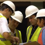 Walker employees conferring on a job site