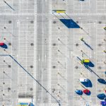 Mostly empty parking lot seen from overhead