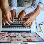 Two people using a laptop together