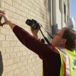 Mike Retterath examines a wall