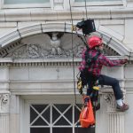 Rope access survey of a building with ornate terra cotta facade