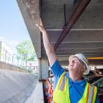 A Walker Consultants engineer performs a condition assessment on a parking structure
