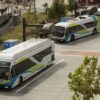 Electric buses charging at a station